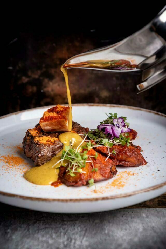Traditional tandoori and clay pot chicken specialties at Vaasu Indian restaurant.